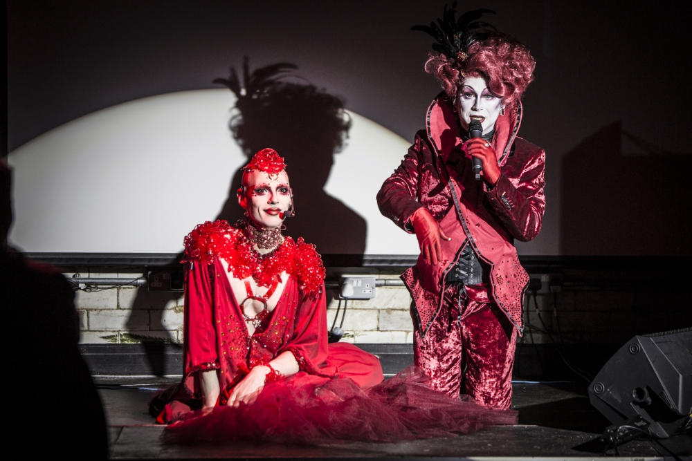 Manchester based performers Cheddar Gorgeous and Anna Phylactic wearing red outfits at a superbia event