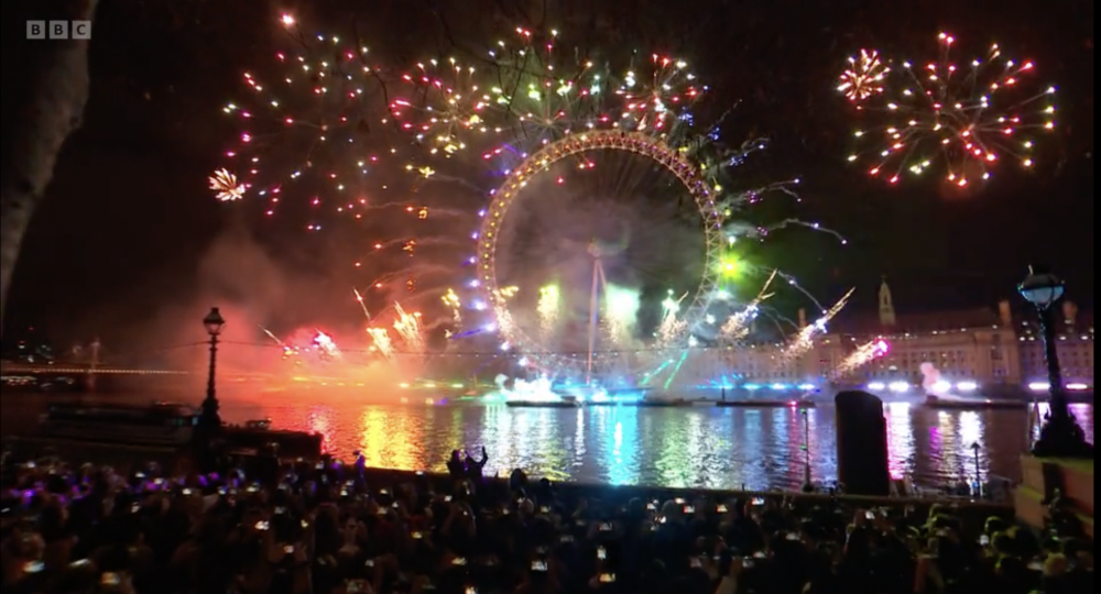The London wheel, illuminated by fireworks making a brilliant rainbow representing the pride flag