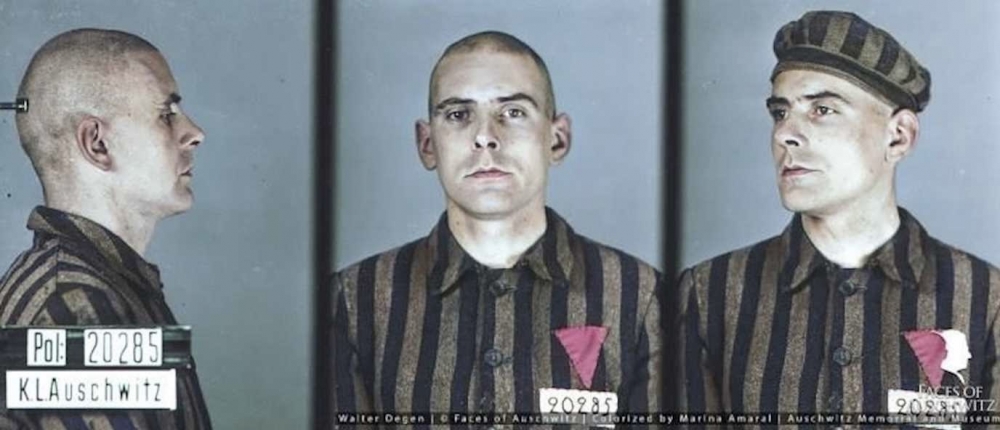 A man in a concentration camp prisoner uniform adorned with a pink triangle facing down